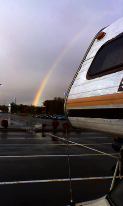 Rainbow craddling the bedroom of the house on wheels.